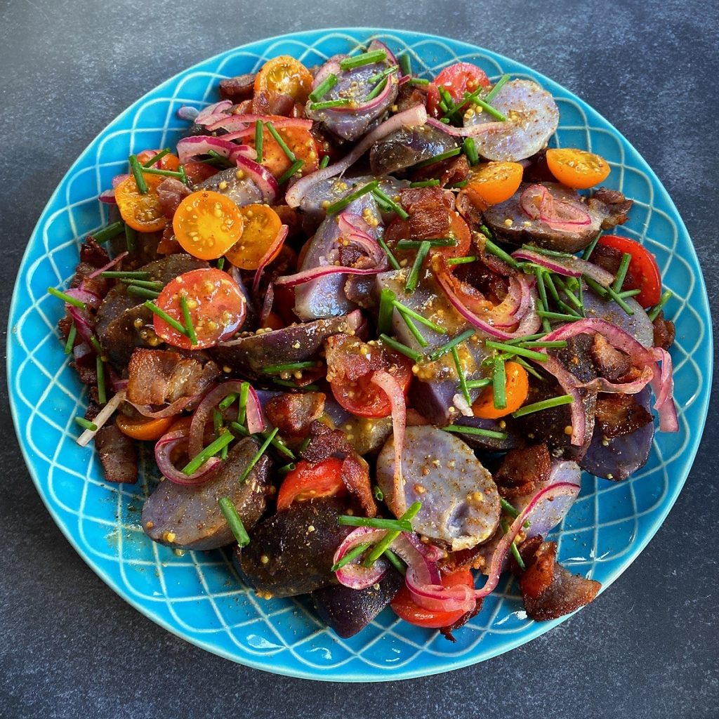 Purple potato, tomato and bacon salad with Old Bay and mustard dressing